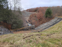 Standing in the valley between the two sides of the trestle. I am looking north towards Hop Brook Lake Dam and the top of the stonework of the railroad-built culvert is visible