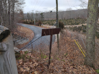 Looking west at the bridge over Merritt Valley Rd. Note the old sign and the Christmas tree farm