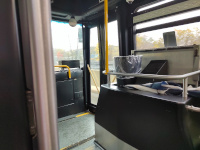 The inside of a CT Fastrak bus. The adjacent Hartford Line is visible outside the window