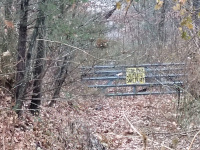 At the Pickett Road Crossing, zoomed in on the gate blocking the roadbed heading west