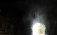 Partway through the tunnel, there's enough light to see the natural color of the walls
