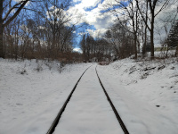At the area where the switch would have been, looking west. The old D&C route is obvious in the snow; the NY&NE tracks to Fiskhill Landing (Beacon) are still present in this 2024 view.