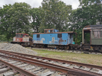 A small locomotove, a caboose, and a coach